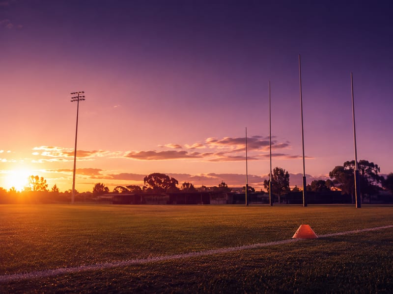 Suburban Australian sports oval at golden hour.